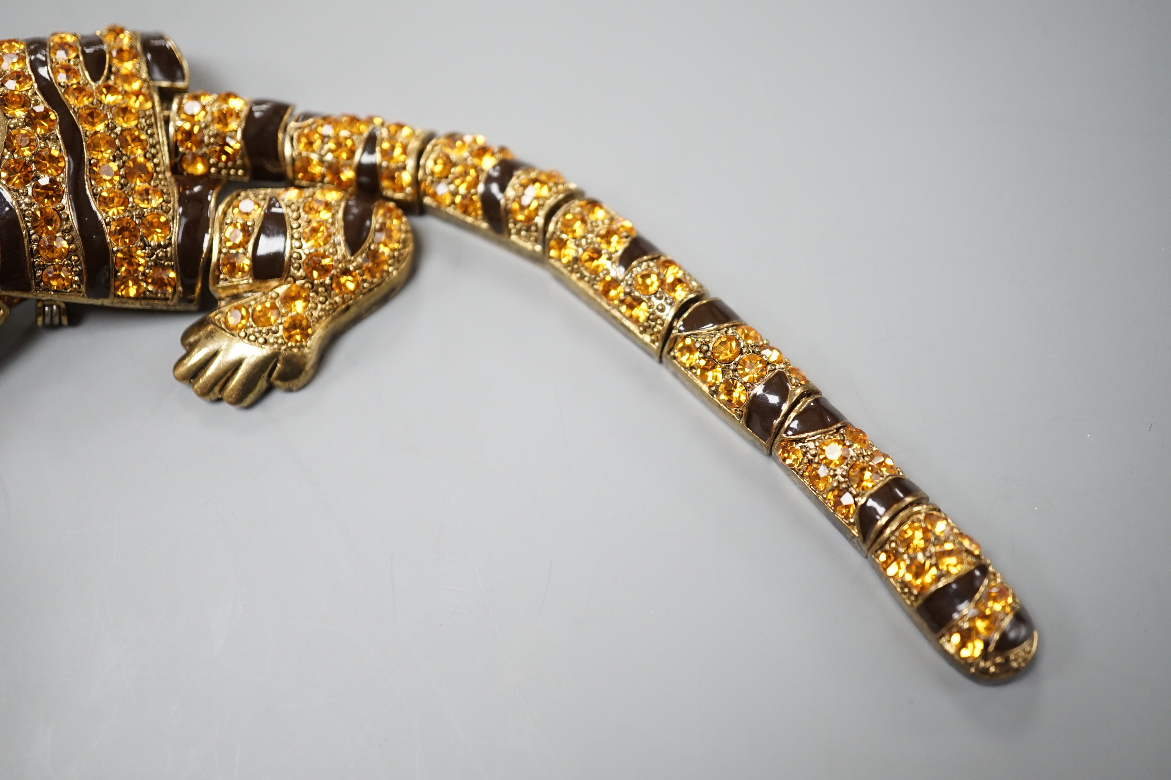 A costume gilt metal and paste set tiger shoulder? ornament, 24.5cm.